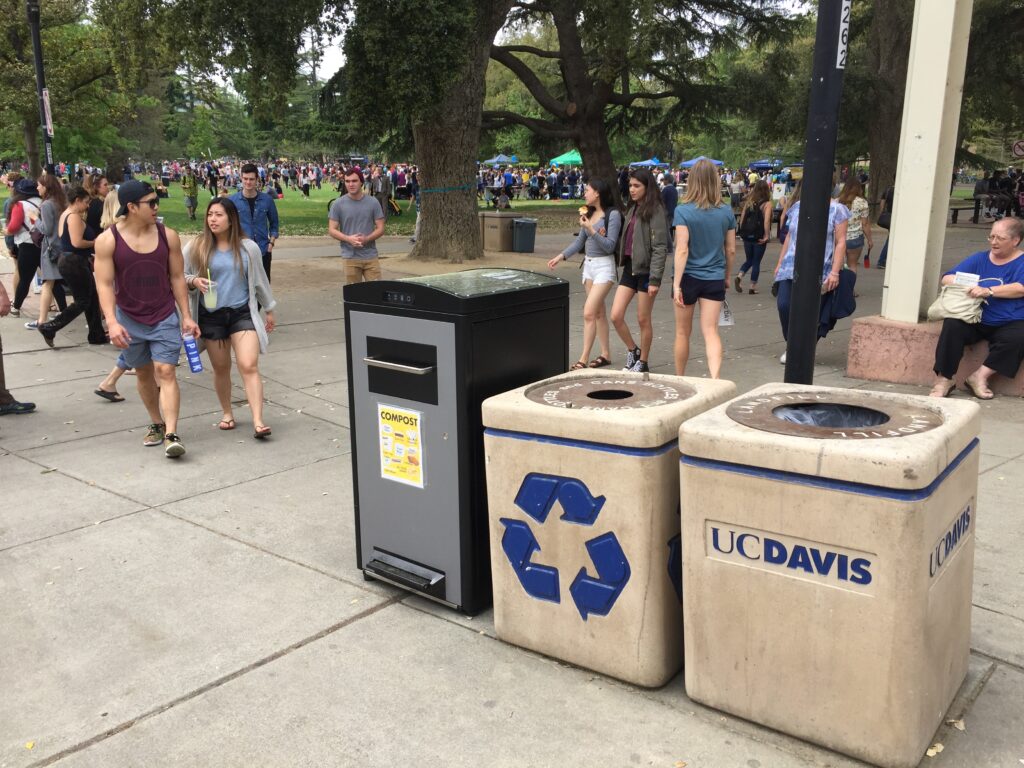 Compacting Trash Cans. Image of compacting trash cans next to traditional trash cans on college campus.